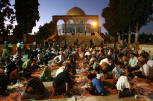Palestinians break their fast with a charity "iftar" feast outside Jerusalem's Dome of the Rock. AHMAD GHARABLI/AFP/Getty Images
